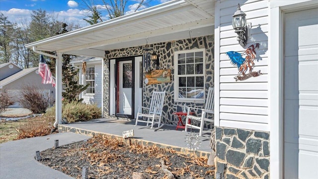 view of exterior entry featuring a porch