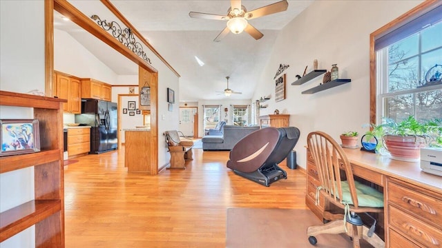 office area with light wood finished floors, ceiling fan, and high vaulted ceiling