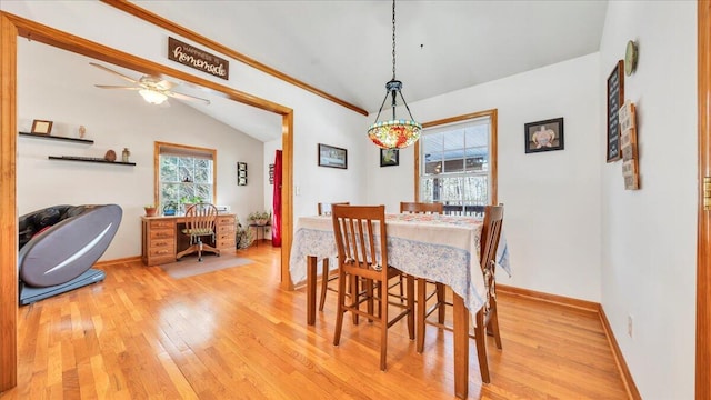 dining area featuring baseboards, vaulted ceiling, wood finished floors, and a healthy amount of sunlight