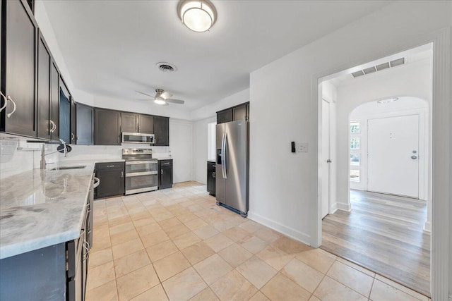 kitchen featuring a sink, visible vents, appliances with stainless steel finishes, and ceiling fan