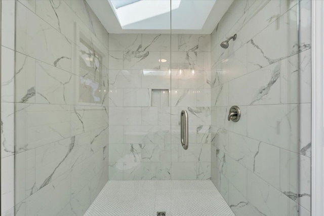 full bath featuring a skylight and a stall shower