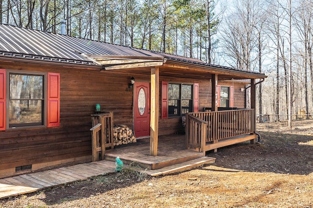 property entrance with crawl space, metal roof, and a standing seam roof