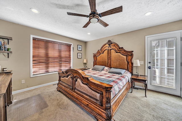 bedroom featuring light carpet, a textured ceiling, and baseboards