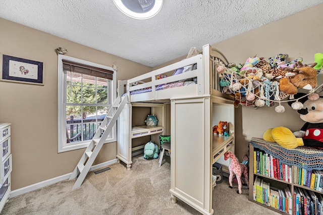 bedroom with carpet, visible vents, a textured ceiling, and baseboards