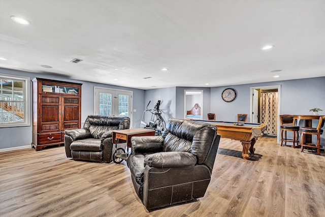 living room with recessed lighting, light wood-style flooring, visible vents, and french doors