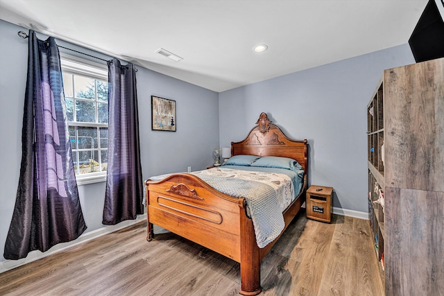 bedroom featuring recessed lighting, wood finished floors, visible vents, and baseboards