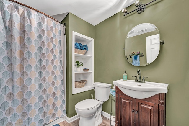 full bathroom with toilet, a shower with curtain, baseboards, and vanity