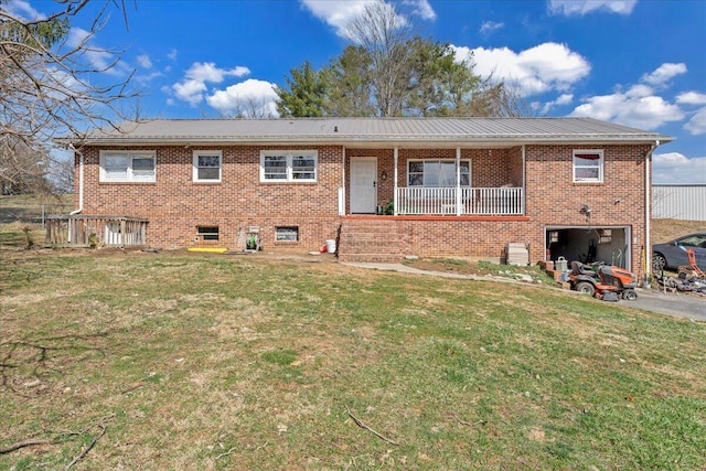 2930 Roanoke St, Christiansburg, VA 24073 - view of front facade featuring a front lawn, an attached garage, brick siding, and metal roof