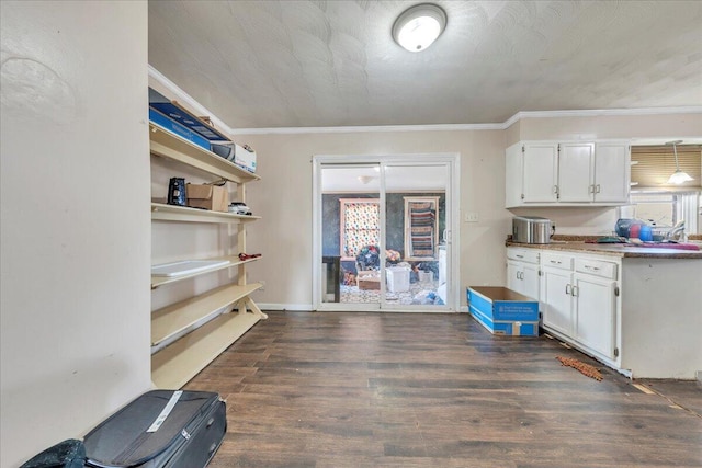 2930 Roanoke St, Christiansburg, VA 24073 - kitchen with baseboards, ornamental molding, dark wood-type flooring, light countertops, and white cabinetry