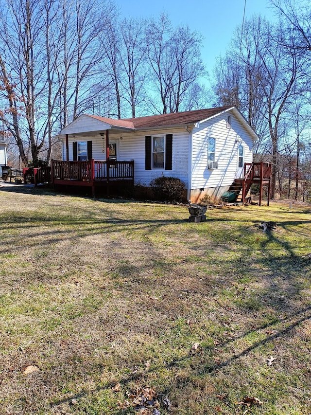 view of front facade with a front lawn, crawl space, and a wooden deck