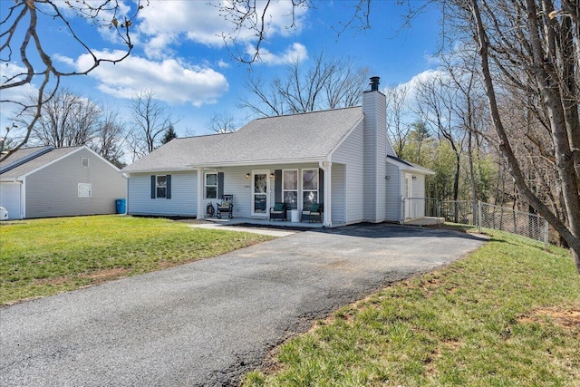 ranch-style home featuring a front lawn, fence, aphalt driveway, covered porch, and a chimney