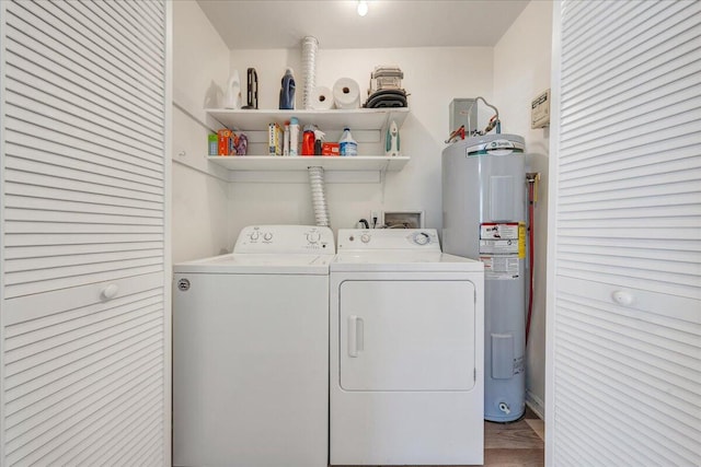 clothes washing area featuring laundry area, washing machine and dryer, and electric water heater