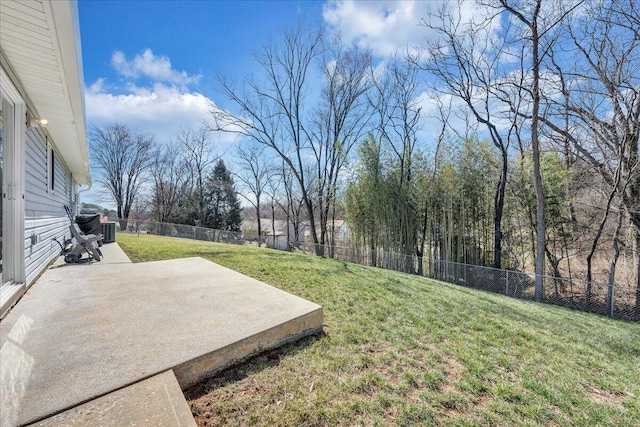 view of yard with cooling unit, a fenced backyard, and a patio area