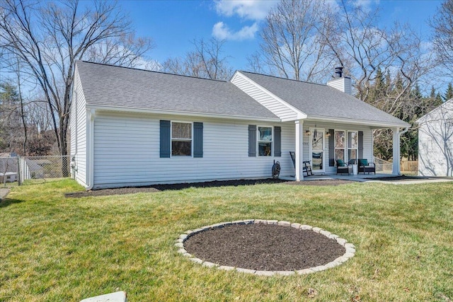 view of front of home with a chimney, a front lawn, roof with shingles, and fence