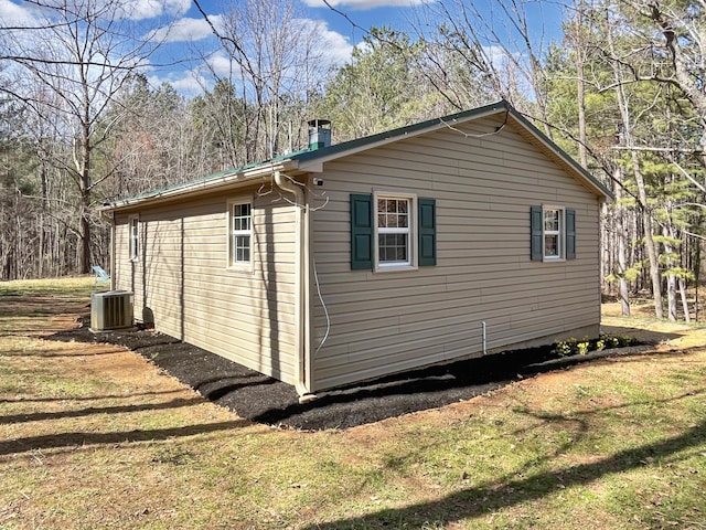 view of home's exterior with a yard and cooling unit