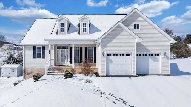 new england style home featuring a garage, an outbuilding, and a storage shed