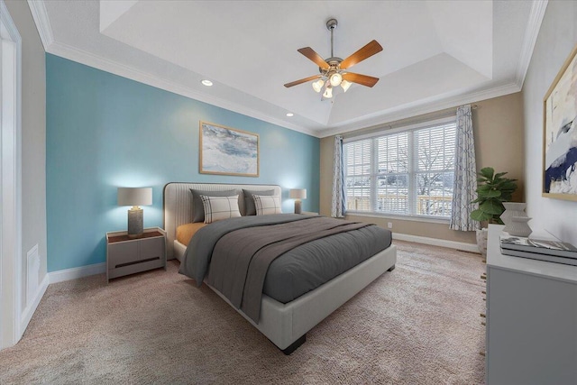 bedroom featuring carpet floors, ornamental molding, a raised ceiling, and baseboards