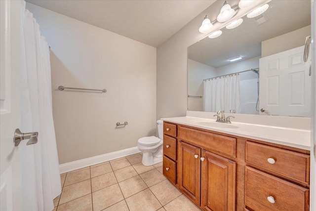 bathroom featuring toilet, vanity, a shower with curtain, baseboards, and tile patterned floors