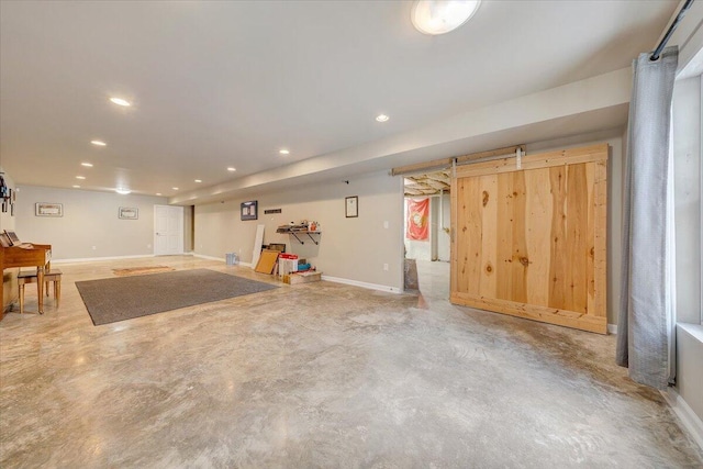 finished basement with baseboards and recessed lighting