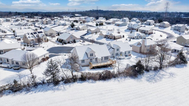 snowy aerial view featuring a residential view