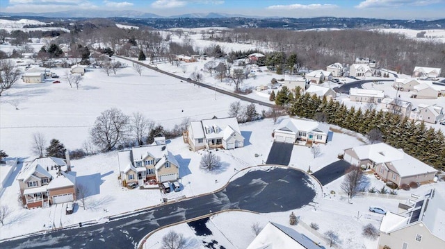 snowy aerial view with a residential view