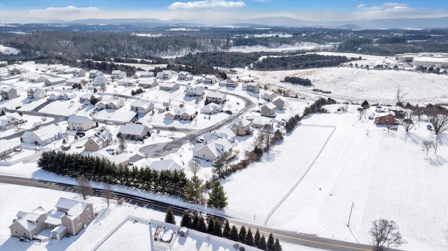 snowy aerial view with a residential view