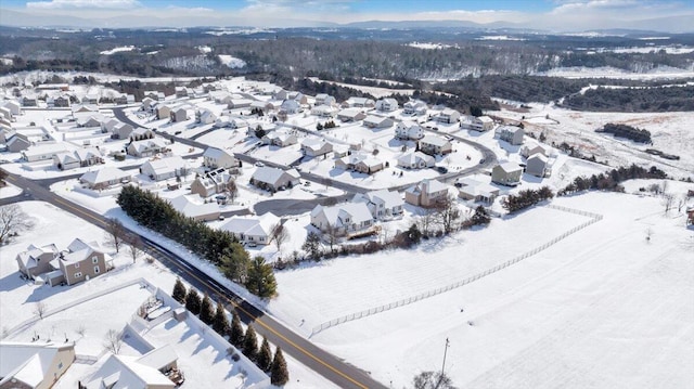 snowy aerial view featuring a residential view