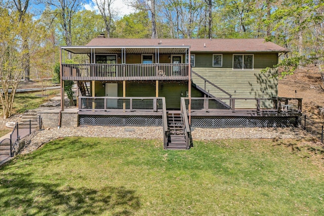 back of house with a lawn, a wooden deck, stairway, and fence
