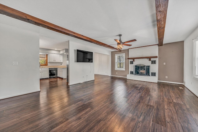 unfurnished living room featuring beamed ceiling, dark wood finished floors, beverage cooler, and ceiling fan
