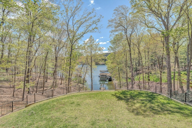 view of yard featuring fence and a water view