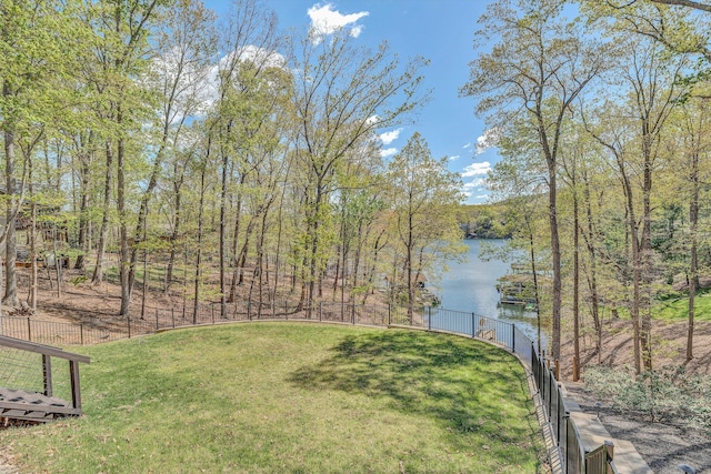 view of yard with fence and a water view