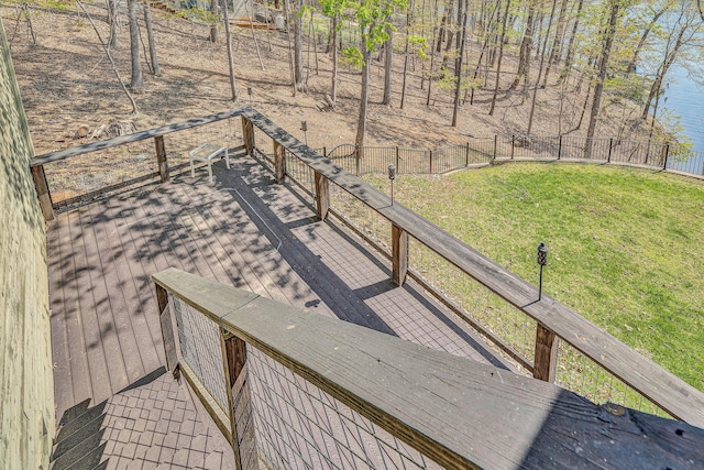 wooden terrace featuring fence and a yard