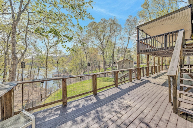 deck featuring stairway and a lawn