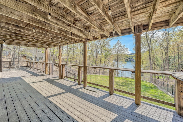 wooden terrace featuring a lawn and a water view