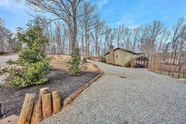 view of yard with stairway, fence, and a deck