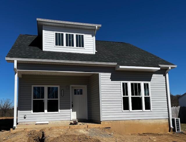 view of front of home featuring central AC and a shingled roof