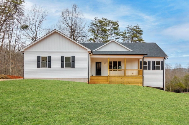 ranch-style house featuring a shingled roof, a front yard, and covered porch