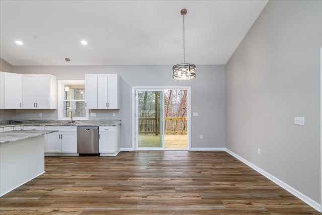 kitchen with an inviting chandelier, pendant lighting, white cabinetry, light stone counters, and dishwasher