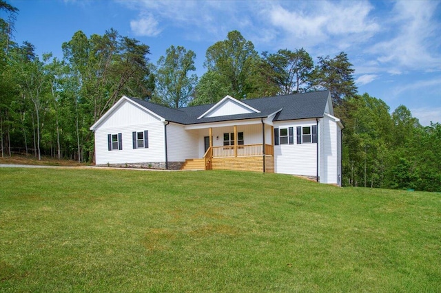 single story home with covered porch, board and batten siding, and a front lawn