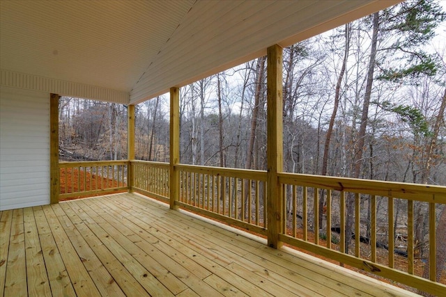 wooden terrace with a wooded view