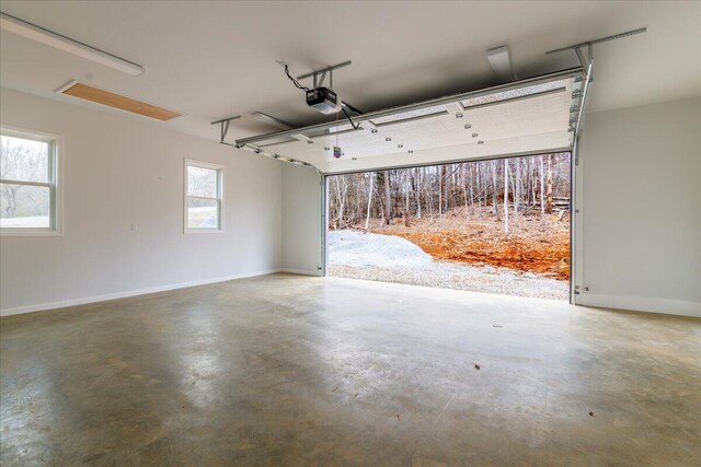 garage with baseboards and a garage door opener