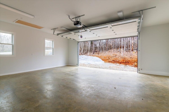 garage with baseboards and a garage door opener