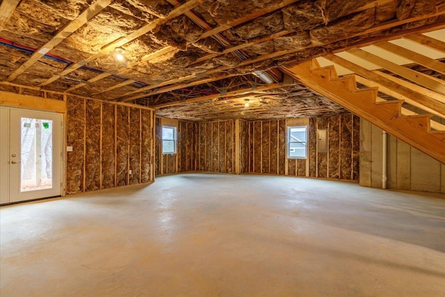 attic with electric panel and plenty of natural light