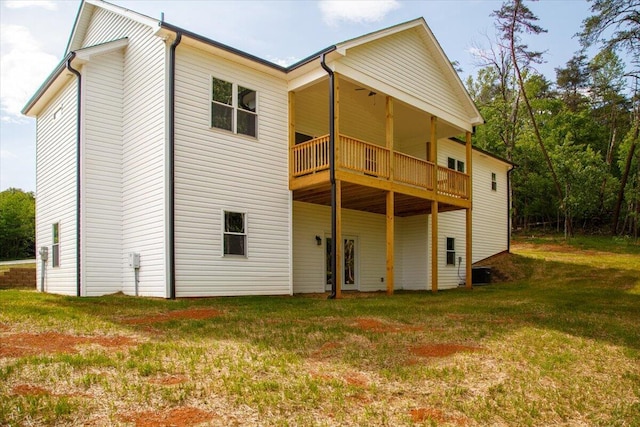 back of house with a lawn and central air condition unit