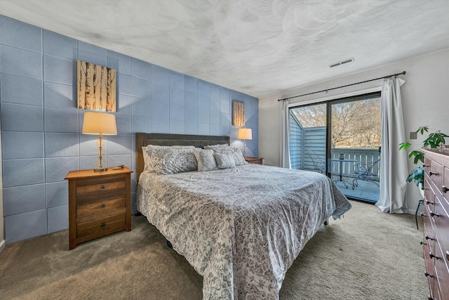 bedroom featuring visible vents, a textured ceiling, carpet, and access to outside