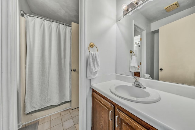 bathroom with a shower with curtain, vanity, and tile patterned flooring