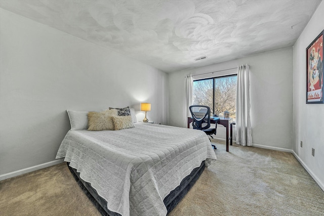 carpeted bedroom featuring visible vents and baseboards