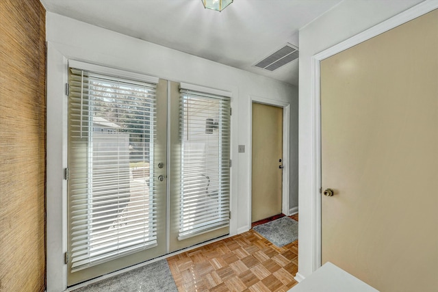 doorway with visible vents and french doors