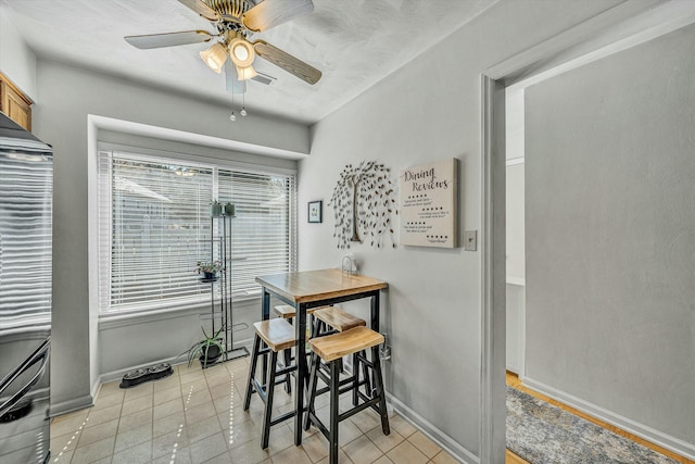 dining area featuring light tile patterned floors, visible vents, baseboards, and a ceiling fan