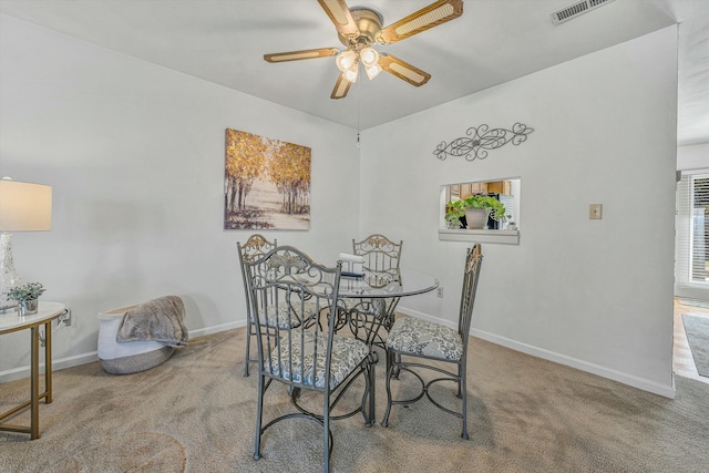 dining area with visible vents, a ceiling fan, baseboards, and carpet floors